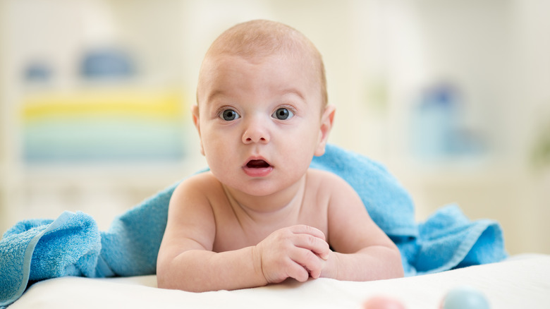 baby wrapped in blue towel