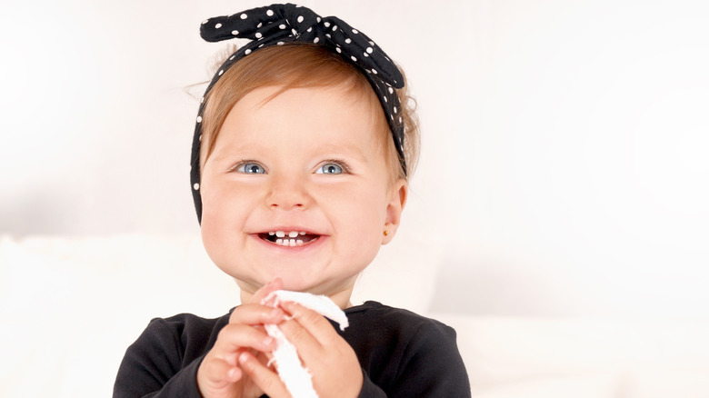 girl with a polka dot bow smiling