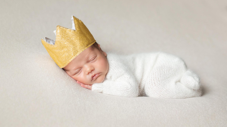 Sleeping baby wearing crown