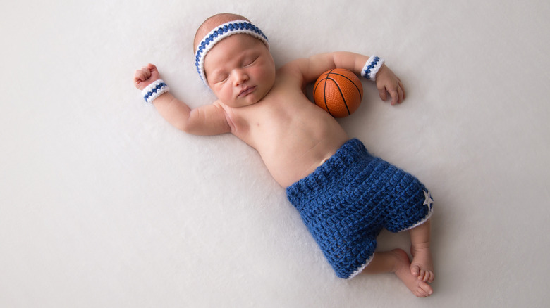 Baby sleeping with basketball