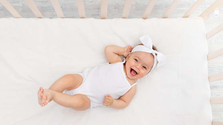 Baby smiling in crib