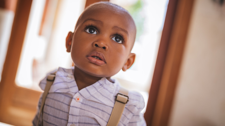 Baby boy looking up