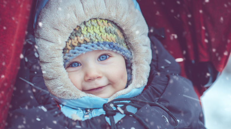 Baby smiling as snow falls
