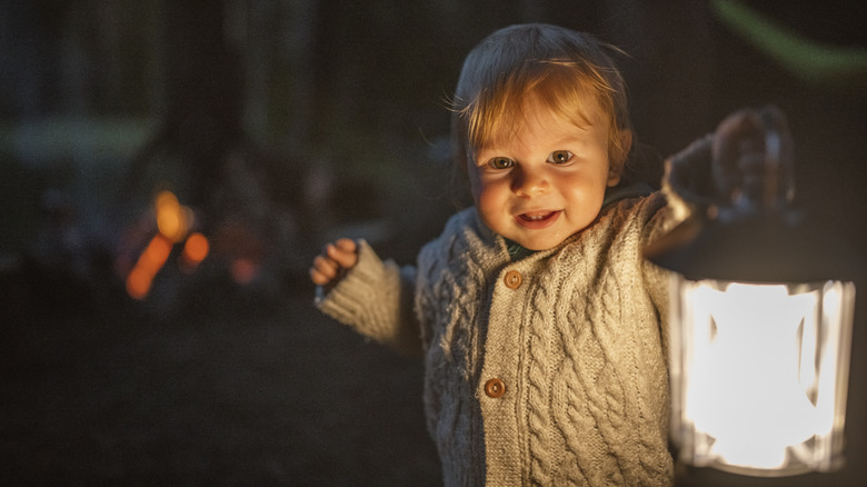 Baby holding lantern