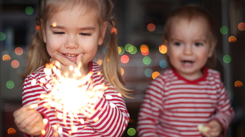 Toddler holding sparkler