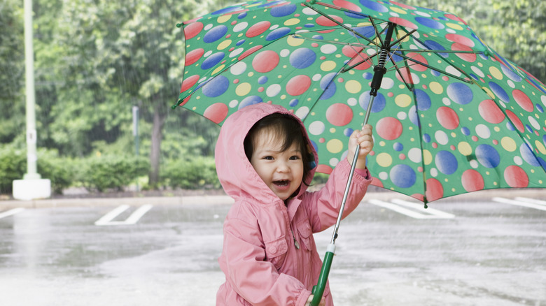 Baby holding umbrella