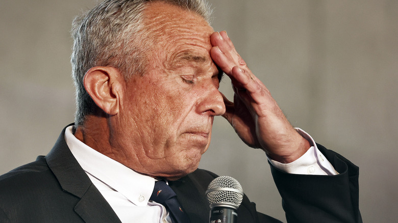 Robert F. Kennedy Jr. with eyes closed, hand to forehead