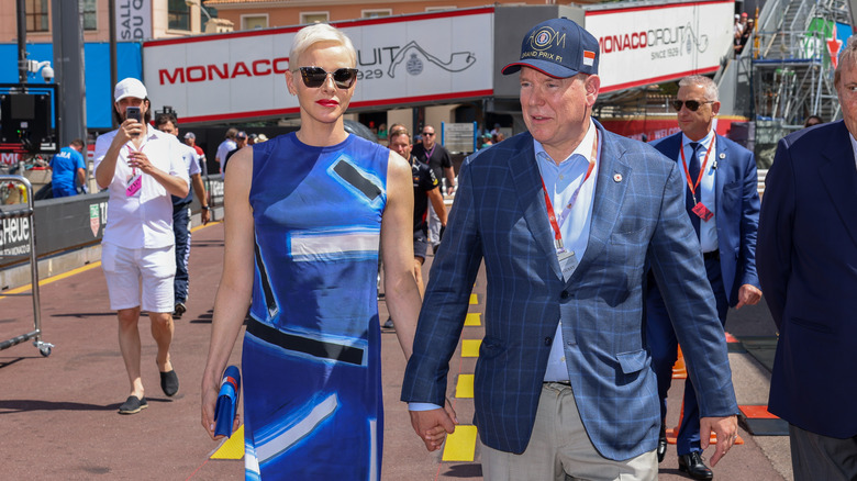 Princess Charlene and Prince Albert holding hands