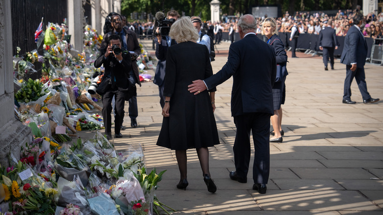 King Charles with arm around Queen Camilla