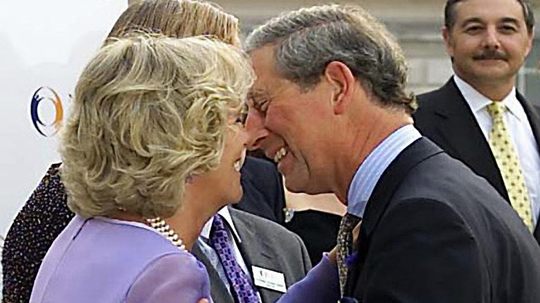 Queen Camilla and King Charles kissing on cheek