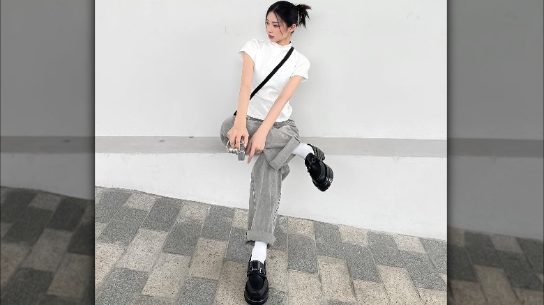 Woman wearing black platform loafers