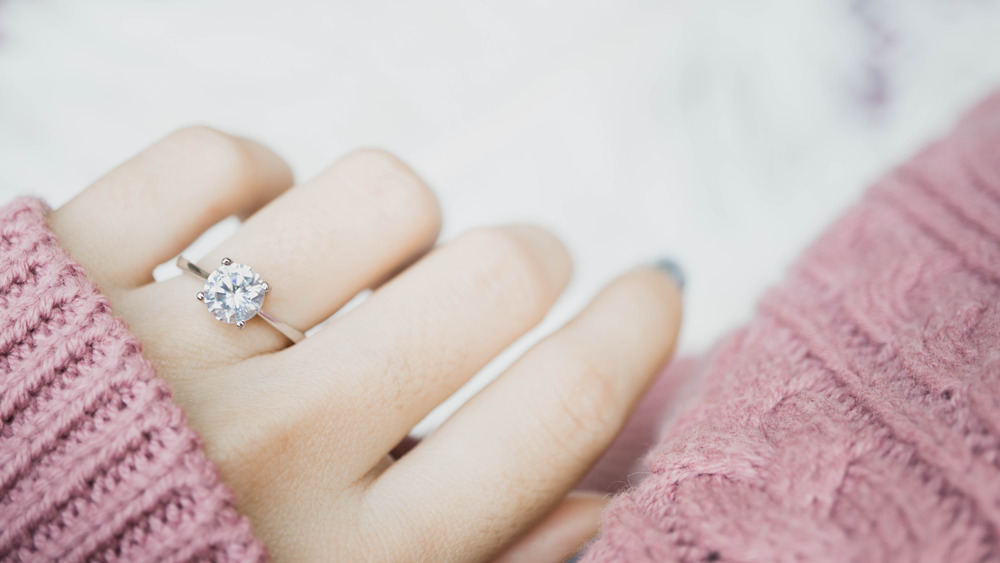 engagement ring on woman's finger