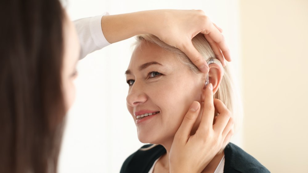 Woman getting fitted for hearing aid