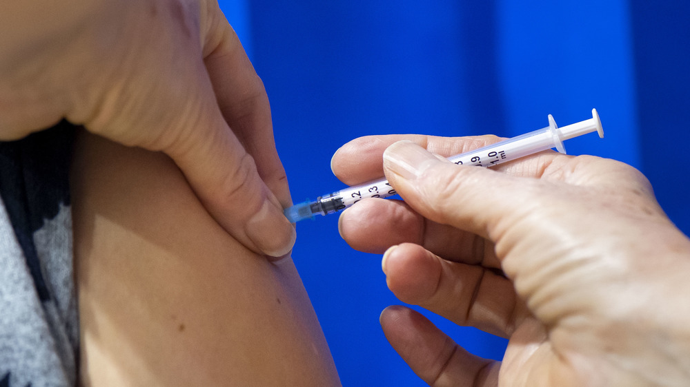 Woman getting COVID-19 vaccine