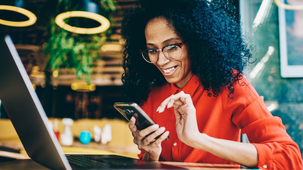 Woman using phone to shop at Walmart