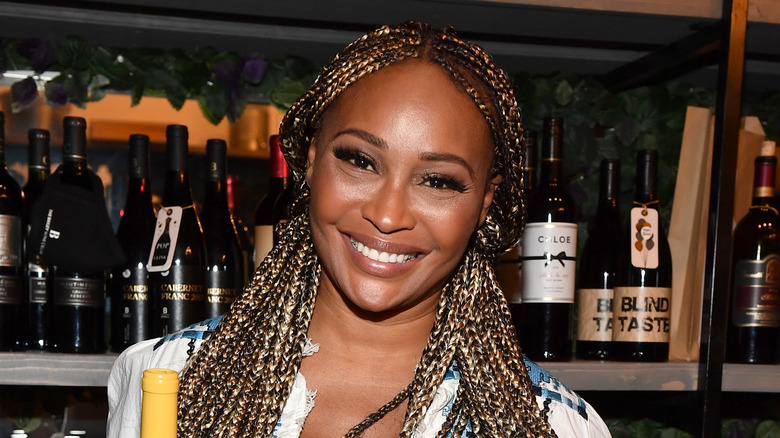 Cynthia Bailey in front of green backdrop