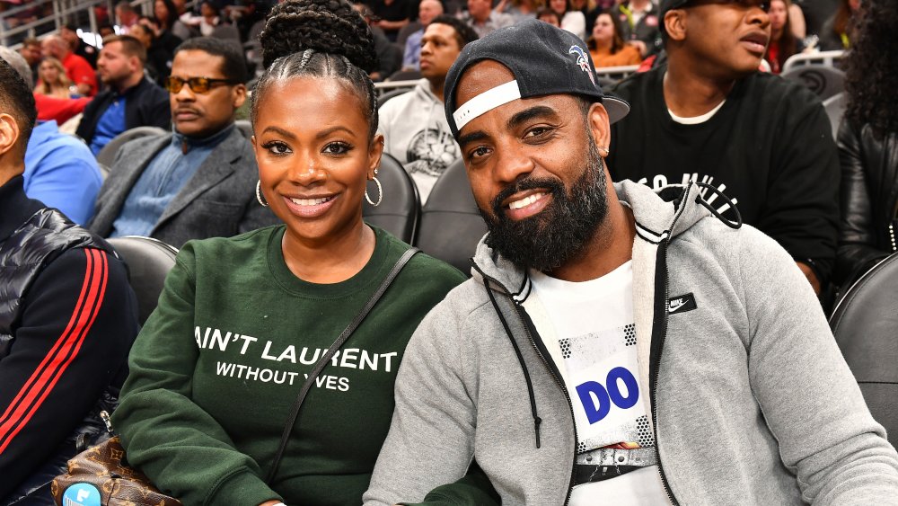 Kandi Burruss and Todd Tucker attend Charlotte Hornets vs Atlanta Hawks game at State Farm Arena on March 09, 2020 in Atlanta, Georgia.