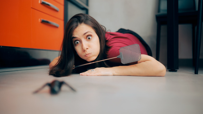 Woman swatting an insect 