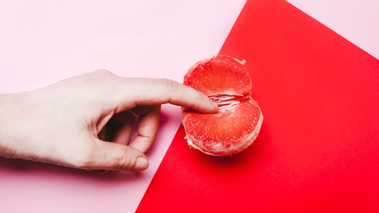 Human hand and grapefruit 
