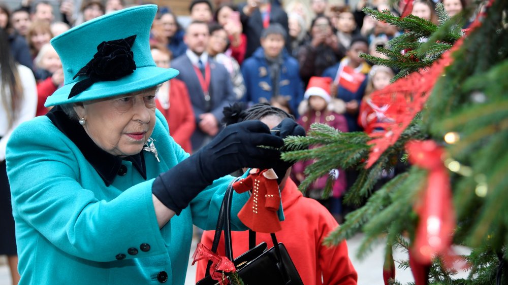 Queen Elizabeth decorating a Christmas tree