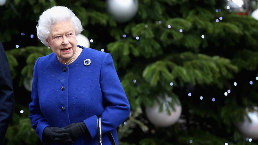 Queen Elizabeth wearing blue in front of a Christmas tree