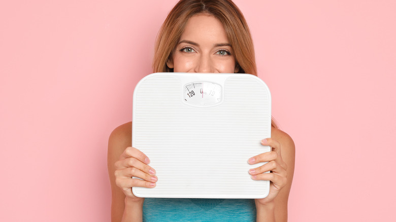 Woman holding scale