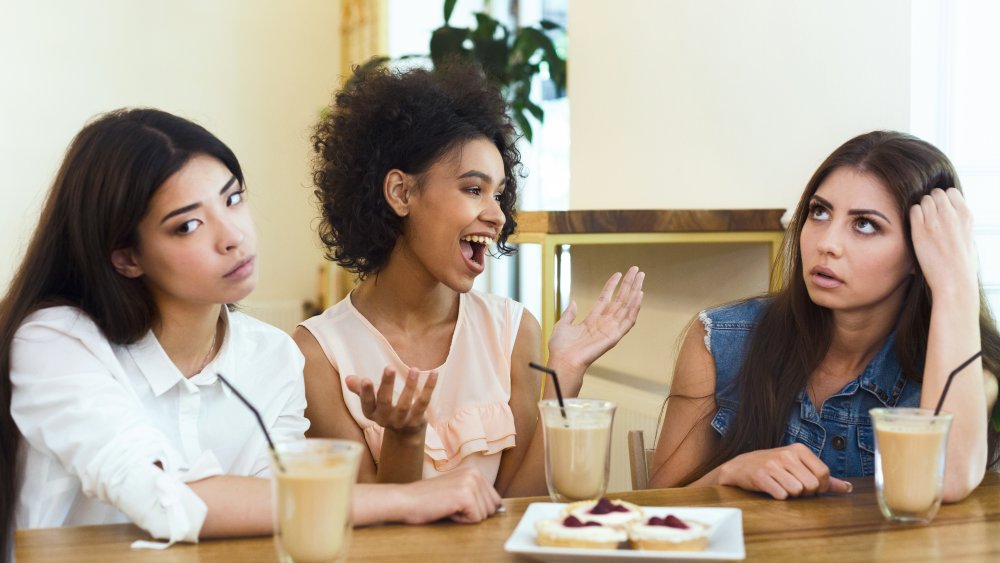 A woman talking, annoying her friends