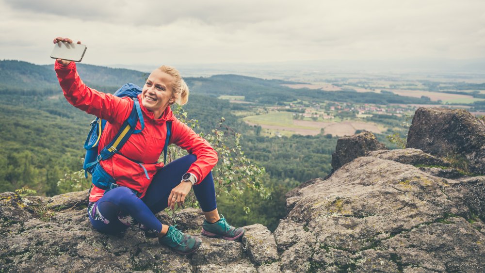 A woman taking a selfie while hiking