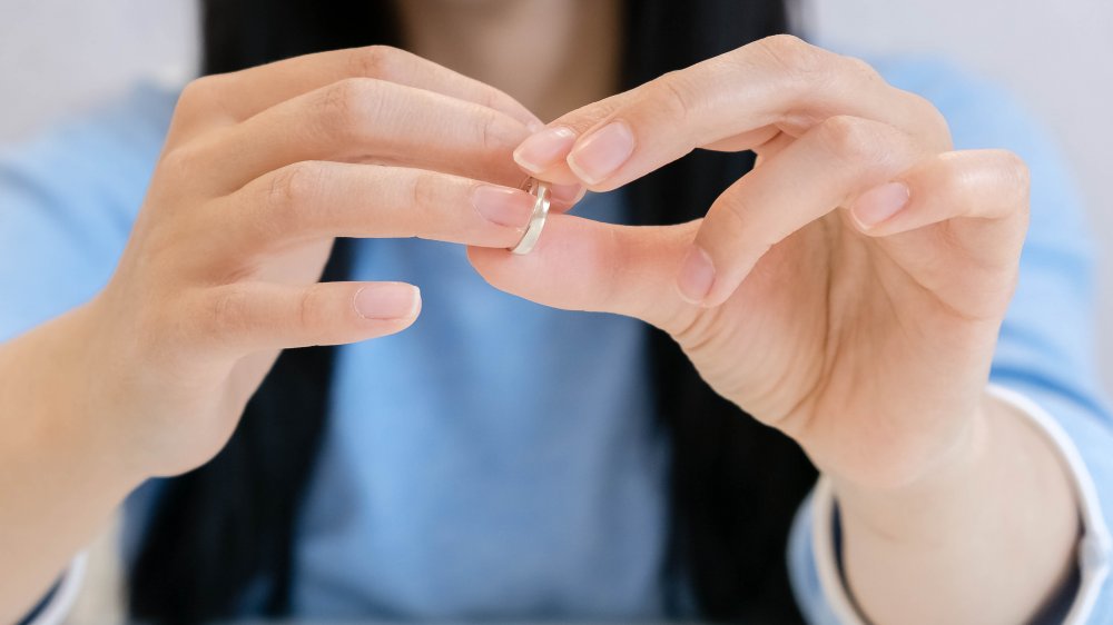 A woman removing her wedding band