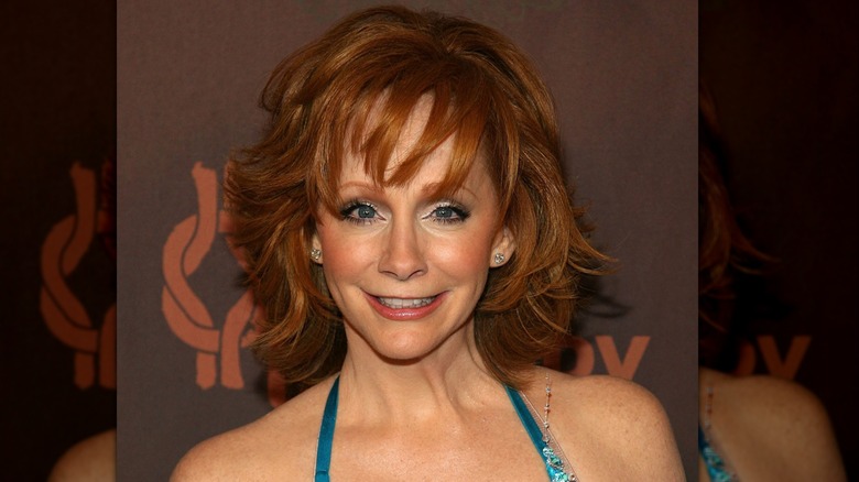 Reba McEntire small smile, glittery eyes, lots of blush.