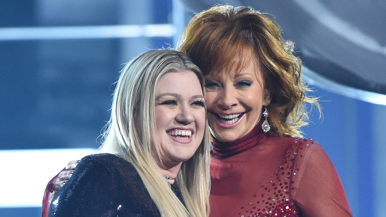 Reba McEntire and Kelly Clarkson onstage