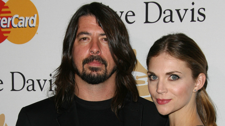 Dave Grohl and wife Jordyn Blum Grohl pose at the Clive Davis Pre-Grammy Awards Party in Beverly Hills (2011)