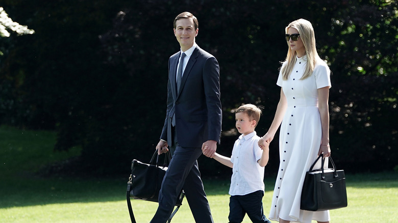 Ivanka Trump and Jared Kushner holding hands with son Joseph