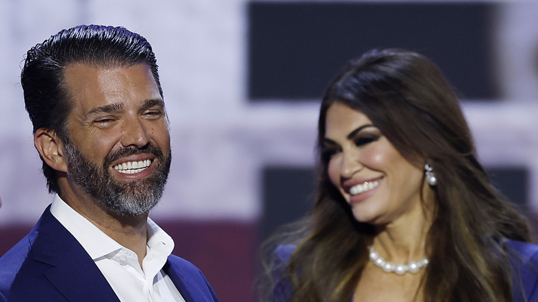 Donald Trump Jr. and Kimberly Guilfoyle smiling with closed eyes