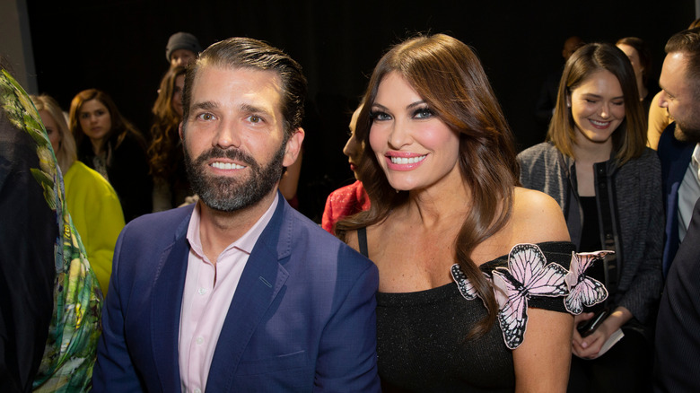 Kimberly Guilfoyle posing with Donald Trump Jr. in formal attire