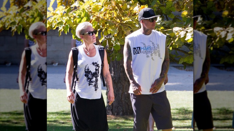 Pink and Carey Hart in a park wearing black and white sleeveless shirts and sunglasses