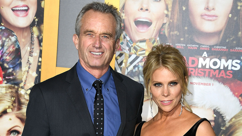 Cheryl Hines and RFK Jr. posing for photos