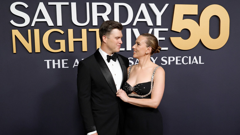 Colin Jost and Scarlett Johansson looking into each other's eyes at the Saturday Night Live 50th anniversary special