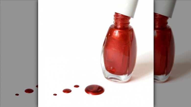 Opened bottle of red nail polish