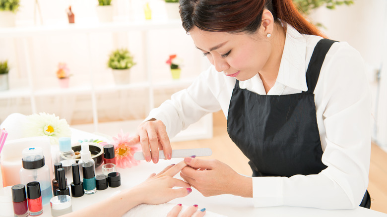 Manicurist doing a woman's nails