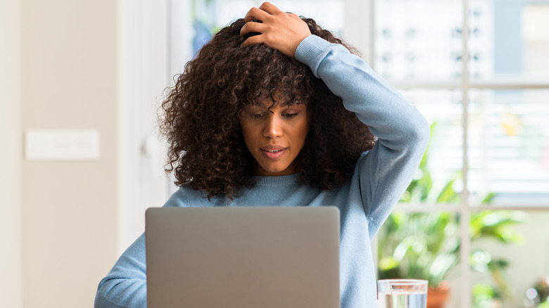 Woman Reads Computer Screen