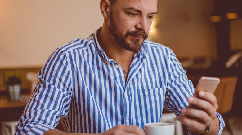 man on phone at cafe