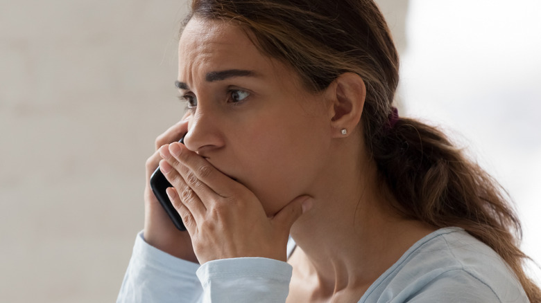 Concerned woman talking on the phone