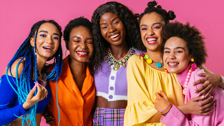 four women dressed colorfully