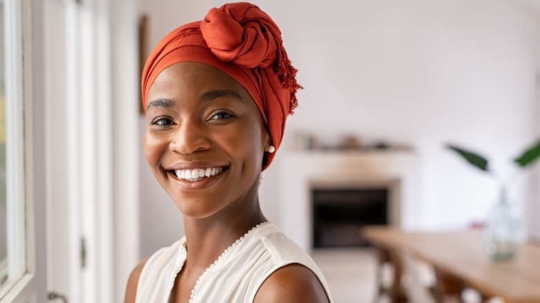 woman in orange head wrap