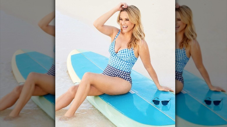 Reese Witherspoon posing in gingham swimsuit