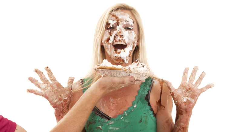 Throwing pie in woman's face