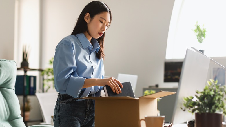 professional woman packing up her desk