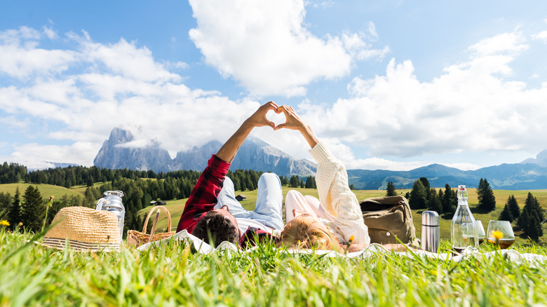 couple on date doing heart hands