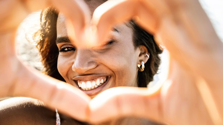 Woman making a love sign